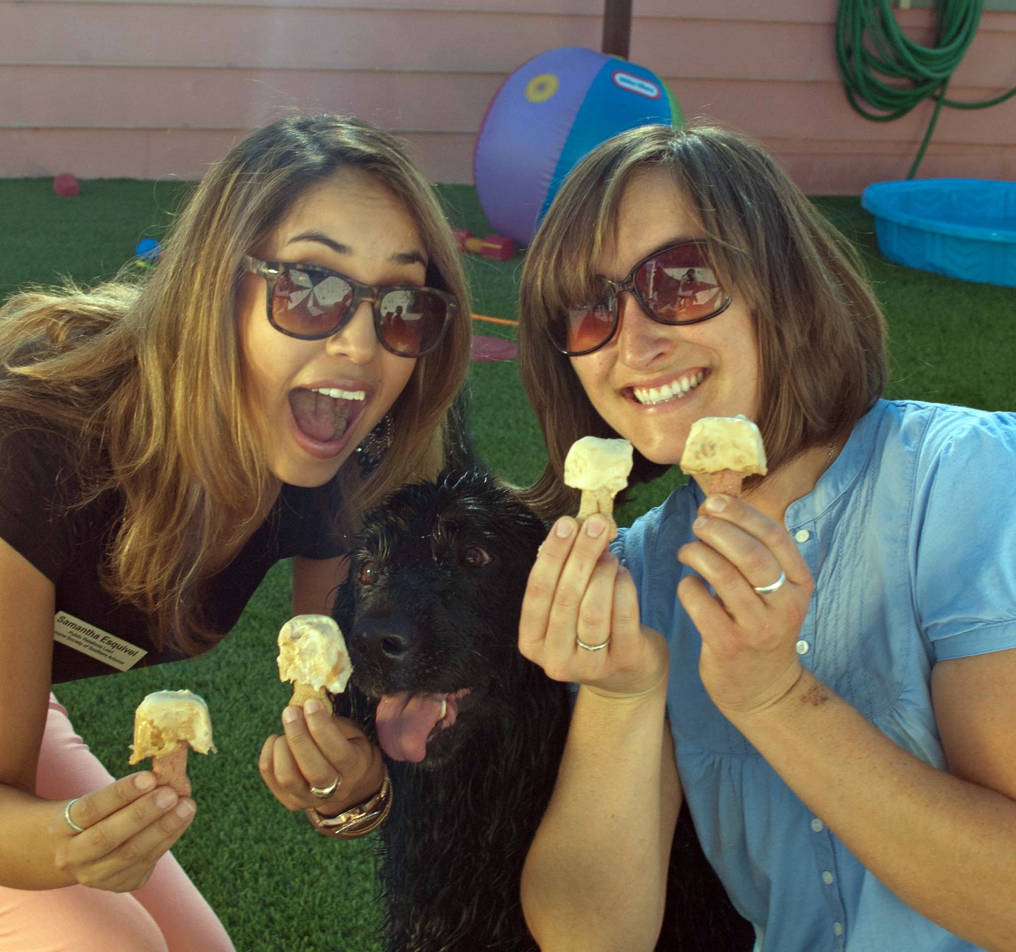 Samantha Esquivel and Sara Gromley from the Humane Society of Southern Arizona share frozen treats with adoptable Benson.